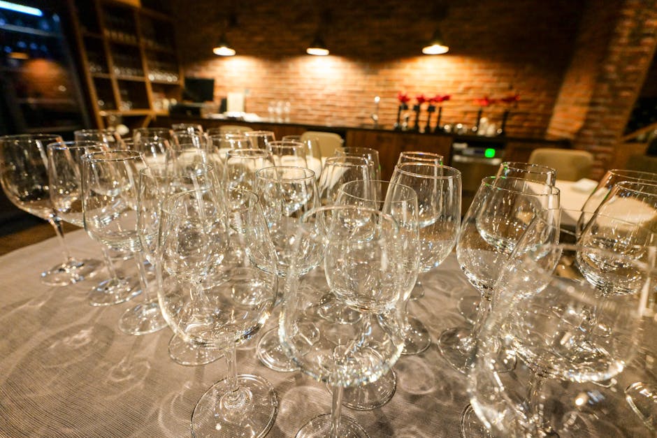 pexels-19393192 elegant wine bar interior with wine glasses and small plates at dusk