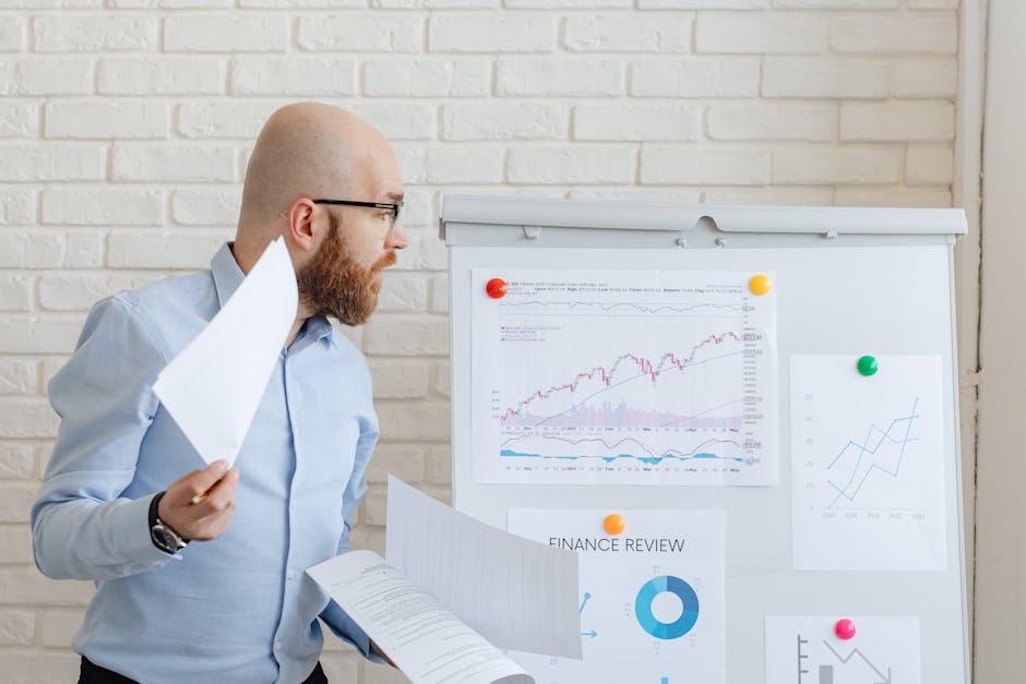 business analyst reviewing customer profitability dashboard spreadsheet in office