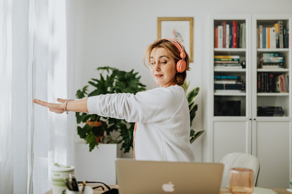 pexels-5899200 person stretching at standing desk casual home office mobility