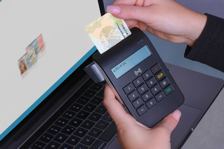 person using smartphone biometric login passkey authentication on laptop