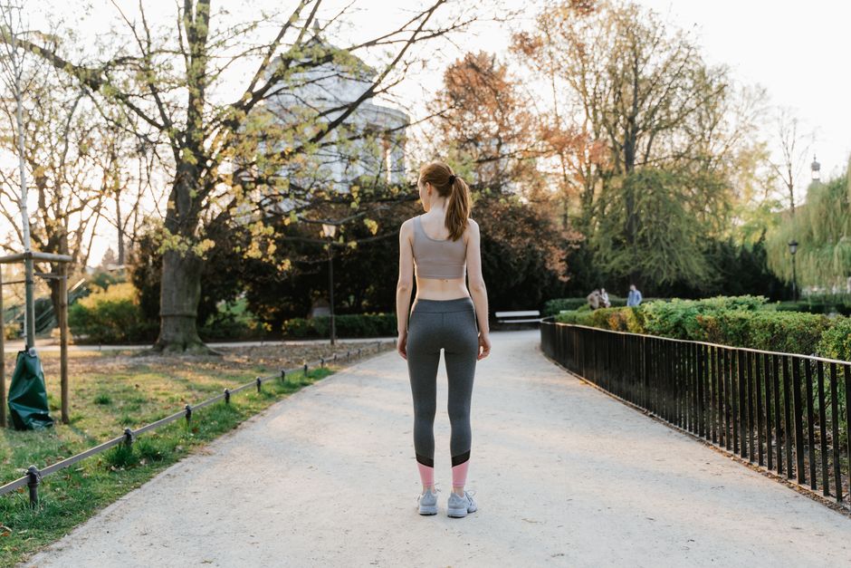 person morning sunlight walk outside city park healthy routine