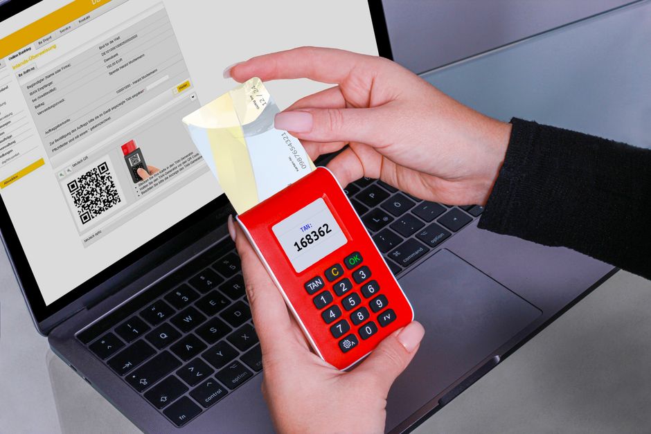 person using security key to login on laptop with smartphone passkey authentication