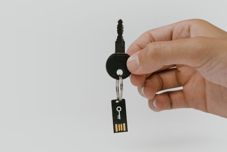 pexels-5474292 person using hardware security key with laptop and smartphone digital security concept