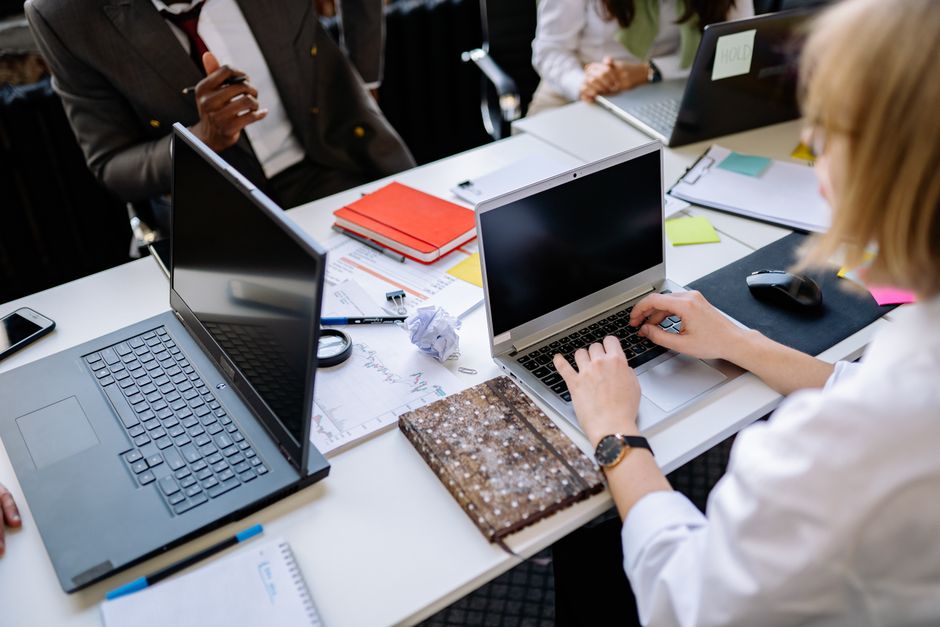 office employees using AI tools on laptops cybersecurity governance concept