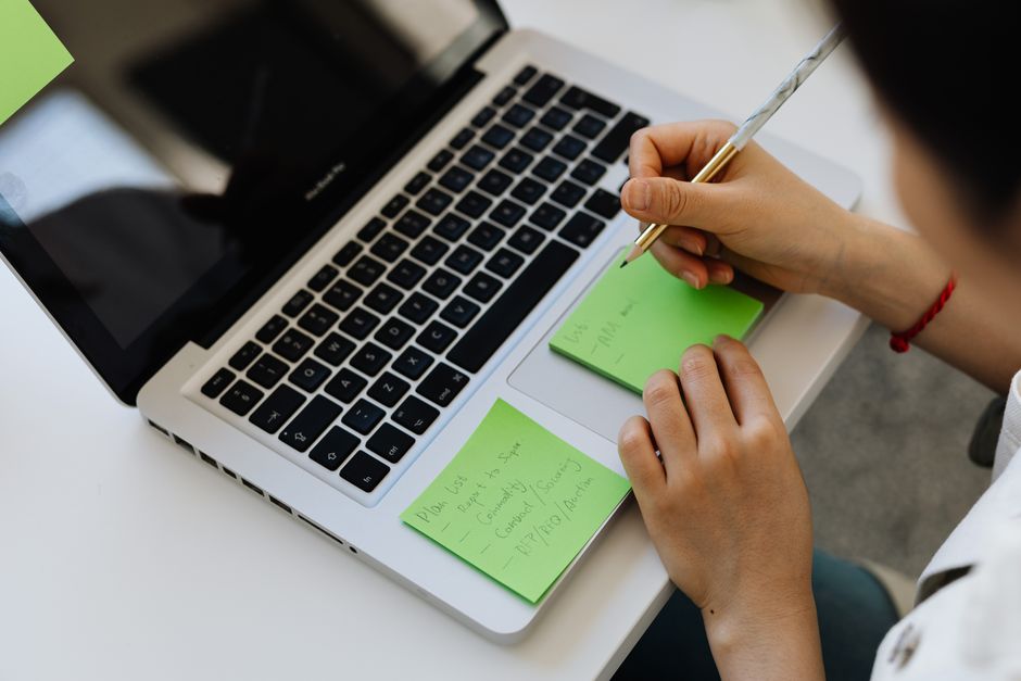 person organizing digital notes on laptop privacy concept