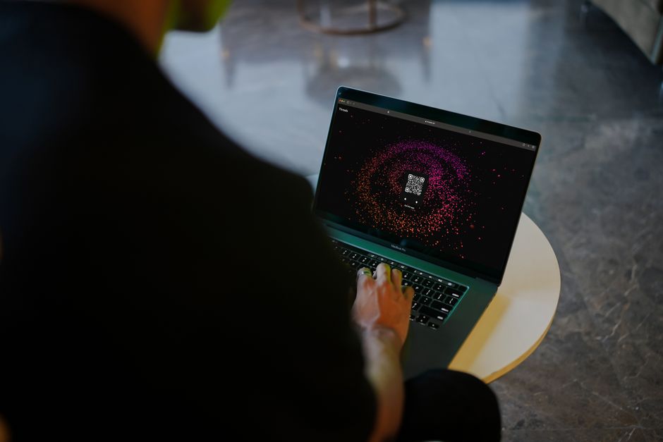 person working at laptop with cybersecurity dashboard and organized digital workspace