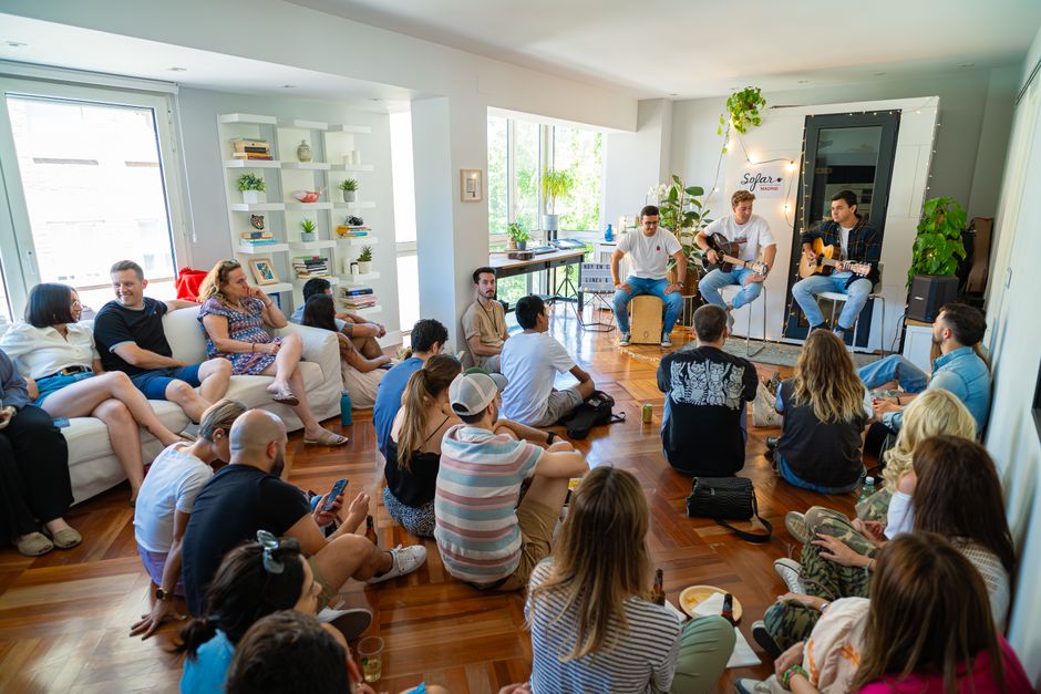intimate living room concert acoustic musician small audience