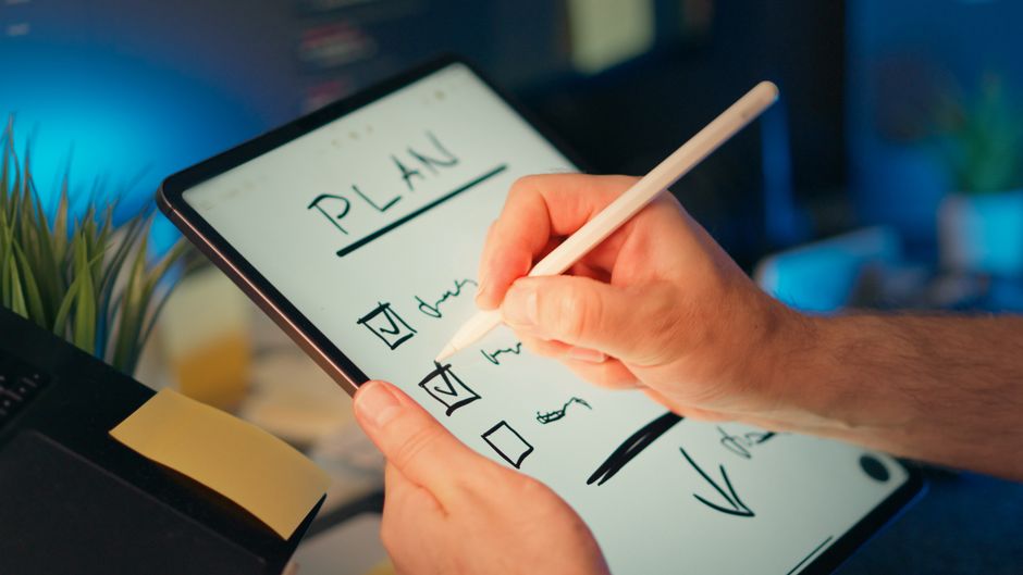 person using laptop with digital notes and AI workflow concept