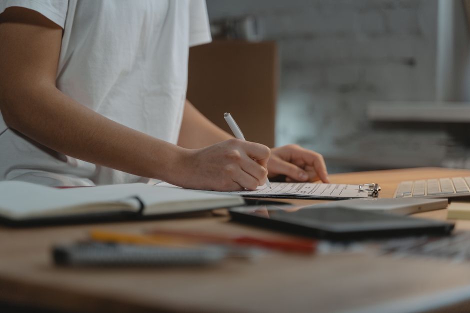 person organizing smartphone privacy settings and laptop security checklist at desk