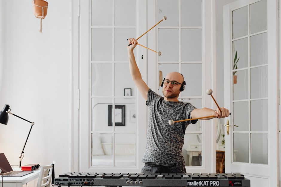 musician practicing with headphones at home small studio lifestyle